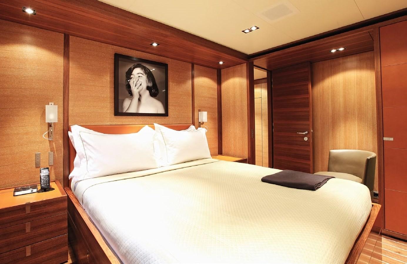 a bed with a white sheet and pillows on it aboard STATE OF GRACE Yacht for Charter