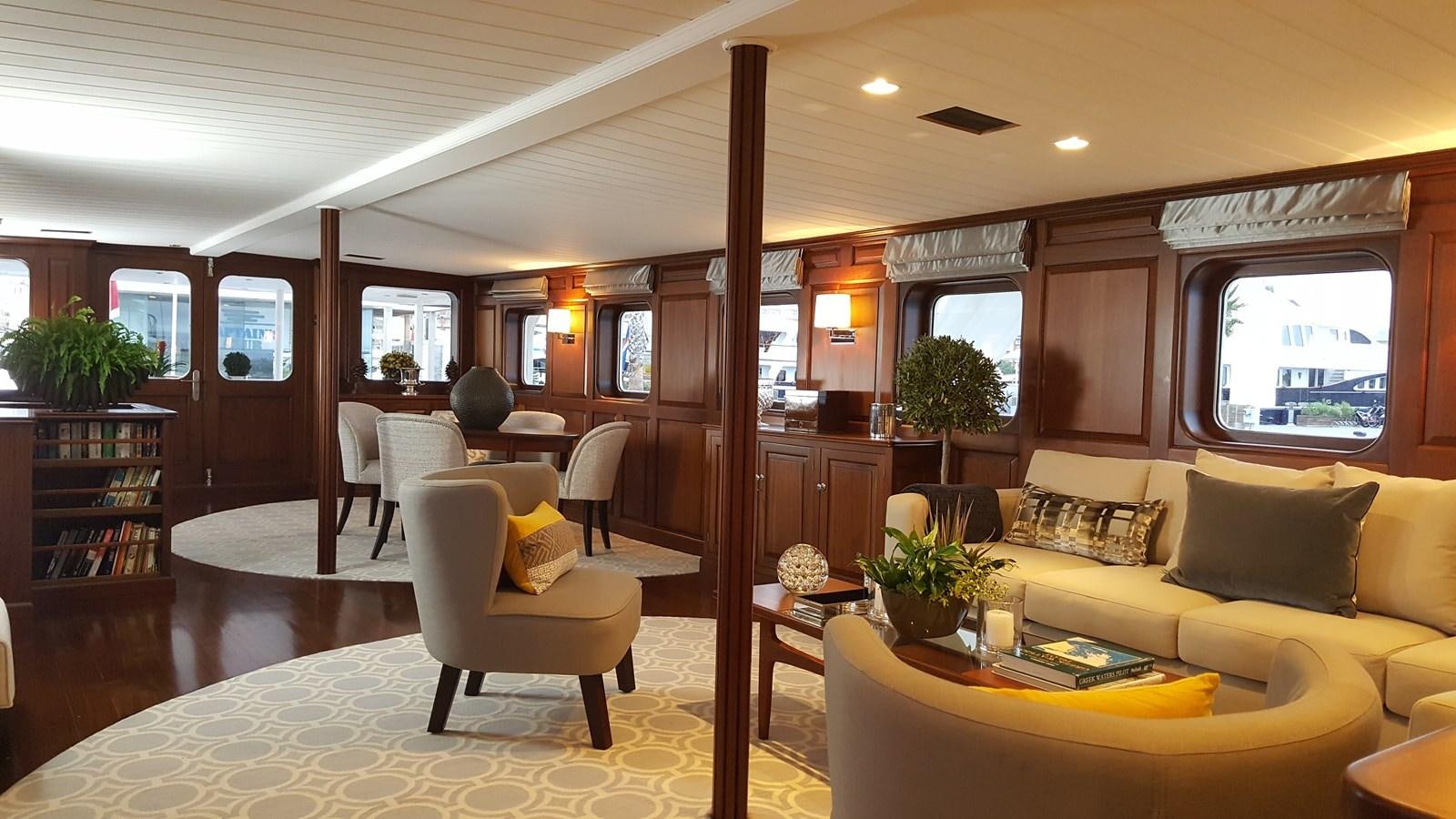 a living room with a couch and a table aboard TRAFALGAR Yacht for Sale