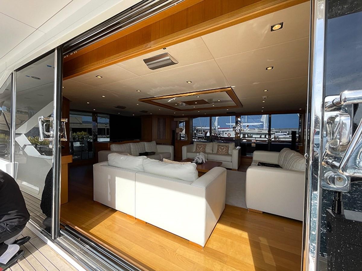 a living room with a large window aboard EVIL ZANA Yacht for Sale