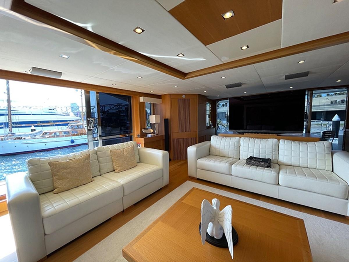 a living room with a large window aboard EVIL ZANA Yacht for Sale