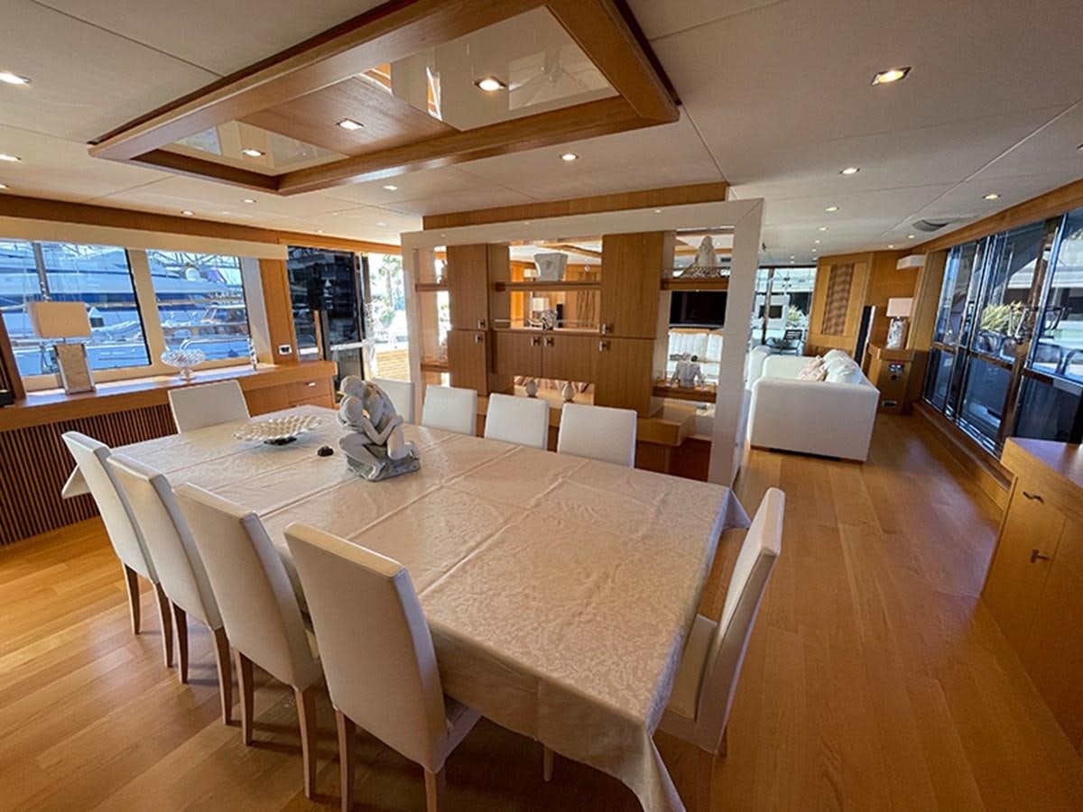 a large room with a table and chairs aboard EVIL ZANA Yacht for Sale