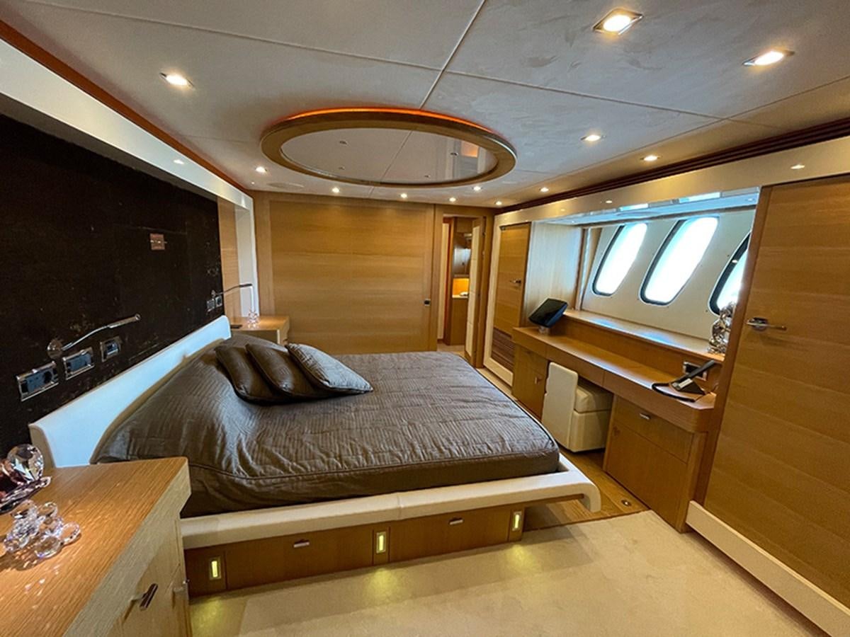 a bedroom with a large bed aboard EVIL ZANA Yacht for Sale