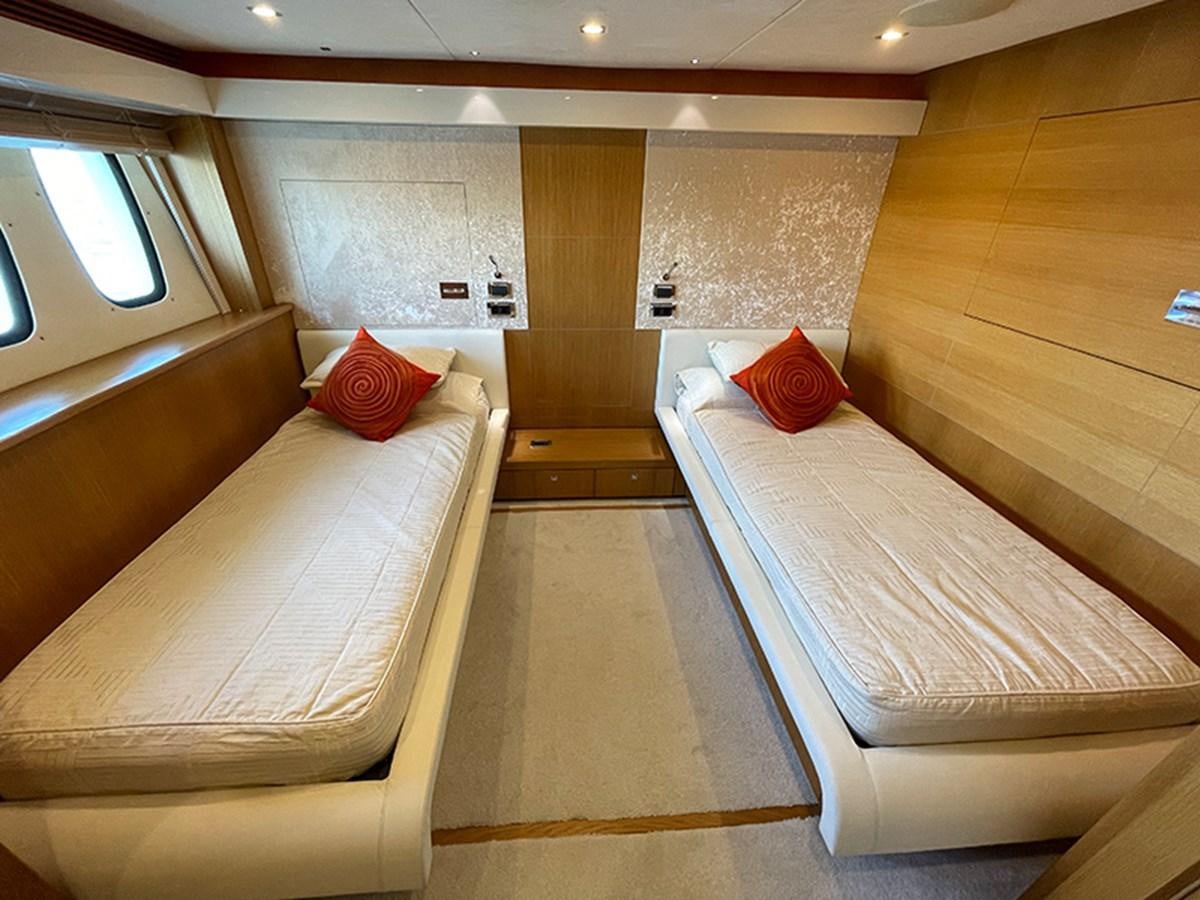 a room with wooden walls and a couple of beds aboard EVIL ZANA Yacht for Sale