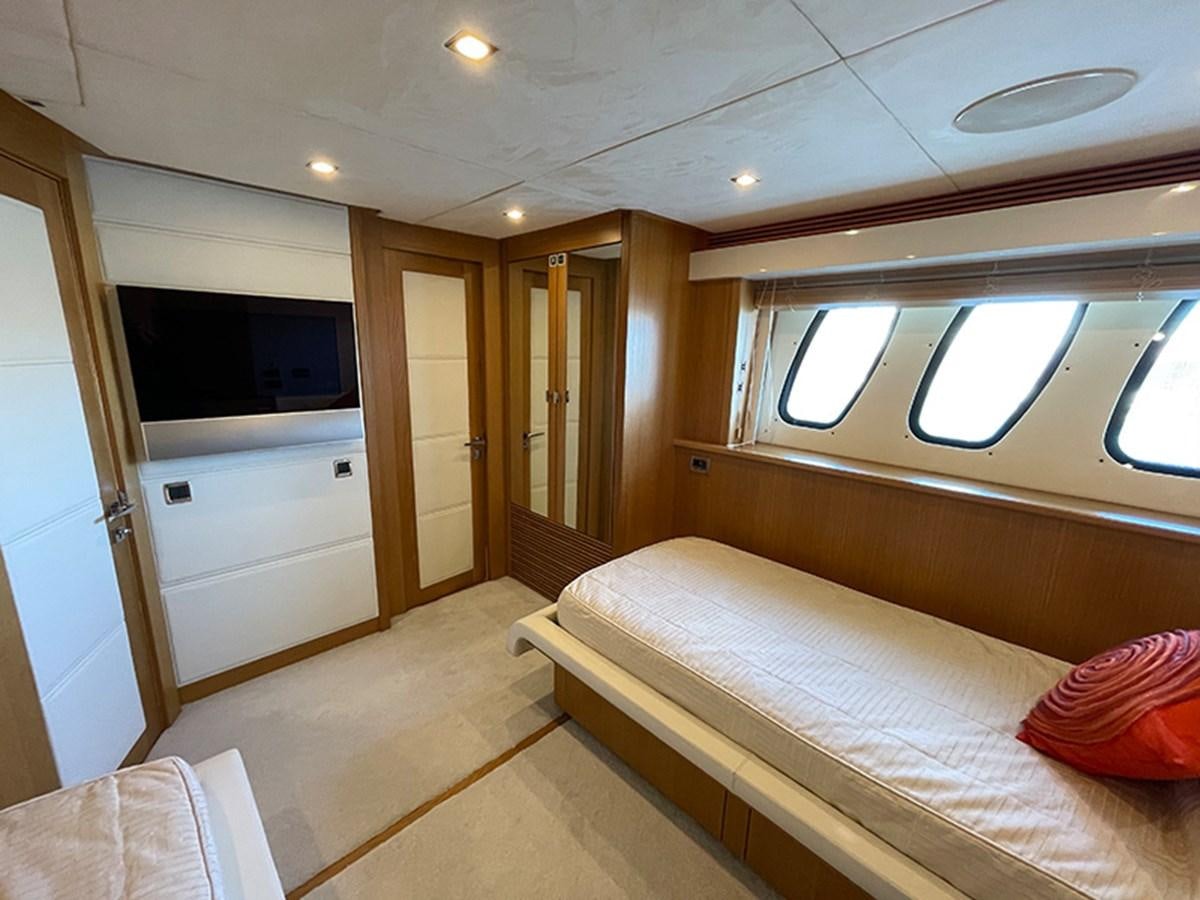 a bedroom with a bed and a tv aboard EVIL ZANA Yacht for Sale