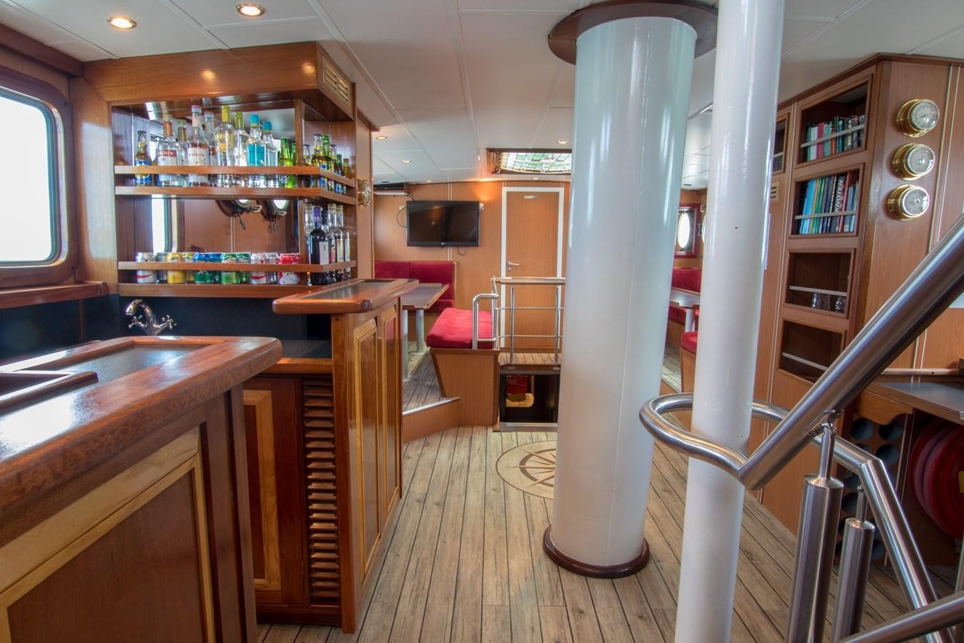 a room with a large white column and a wood staircase aboard ELDORADO Yacht for Sale