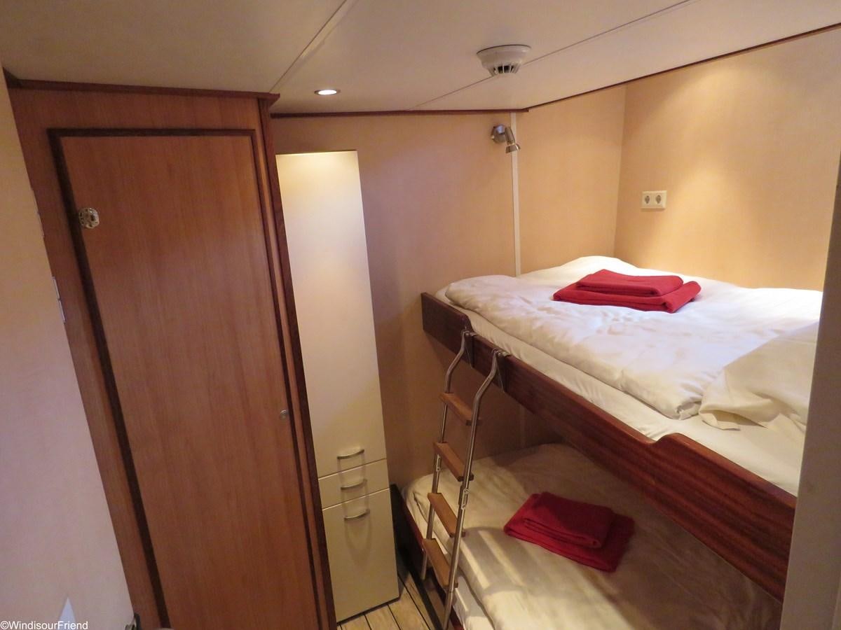 a room with a bed and a lamp aboard ELDORADO Yacht for Sale
