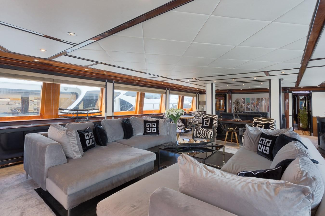 a living room with a large window aboard INDIGO STAR I Yacht for Charter