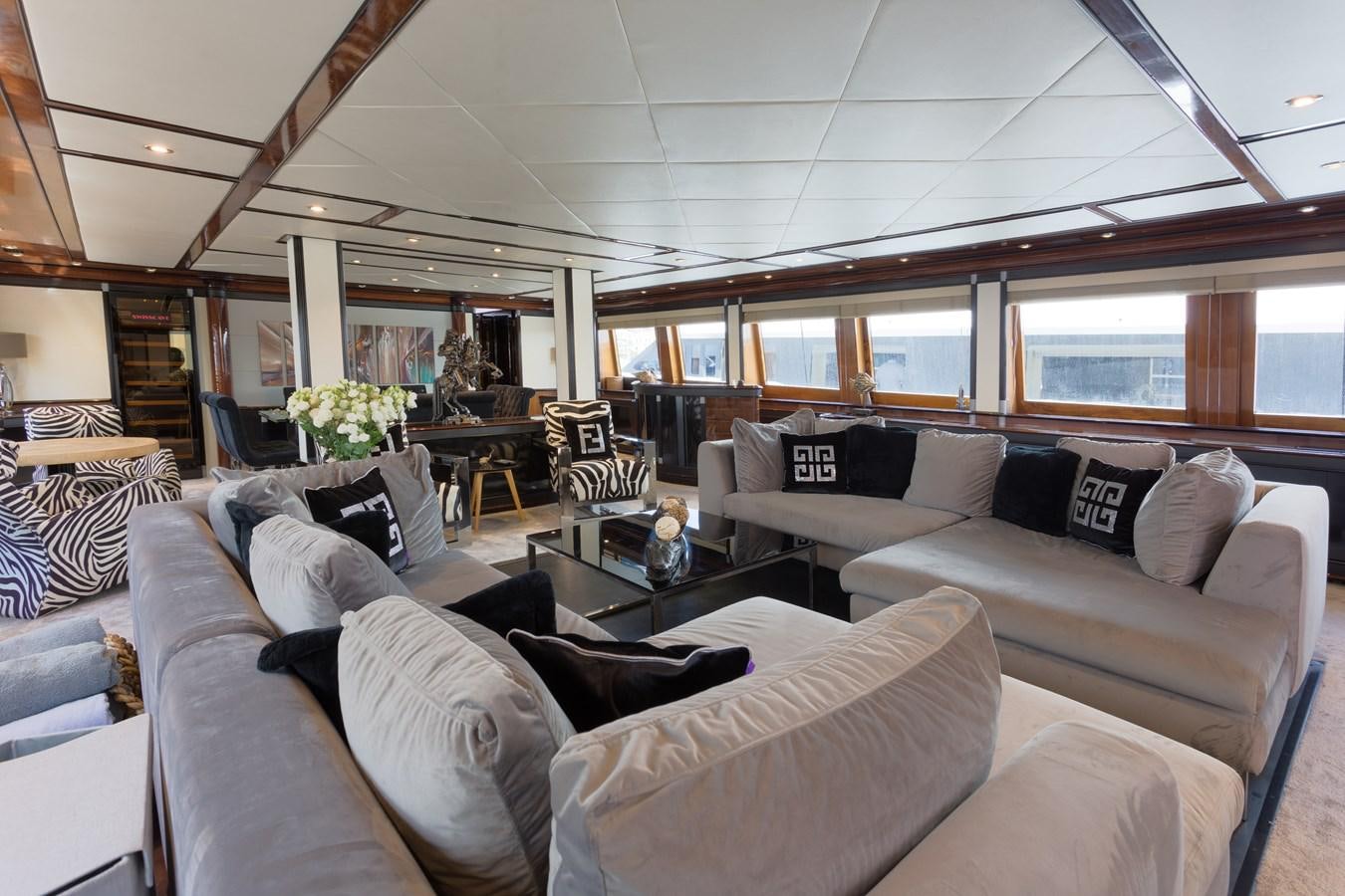 a living room with couches and a table aboard INDIGO STAR I Yacht for Charter