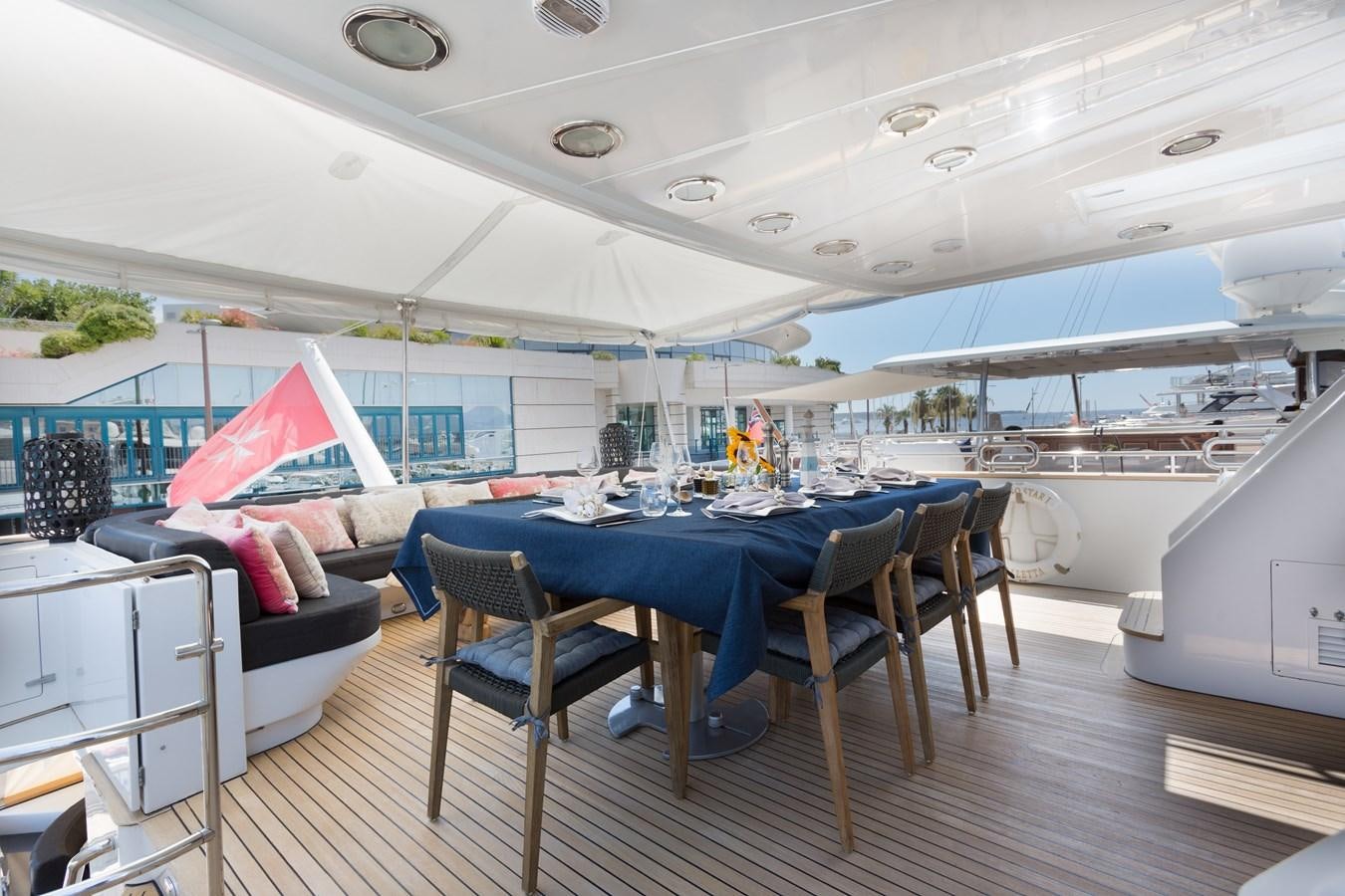 a large blue table with chairs around it aboard INDIGO STAR I Yacht for Charter