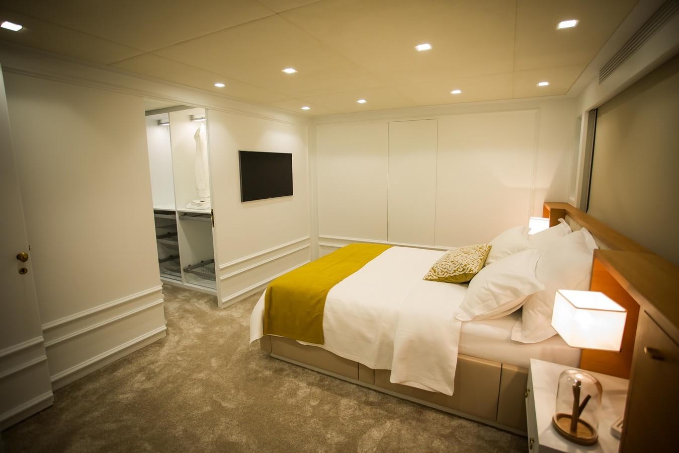 a bedroom with a bed and a television aboard HARUN Yacht for Sale