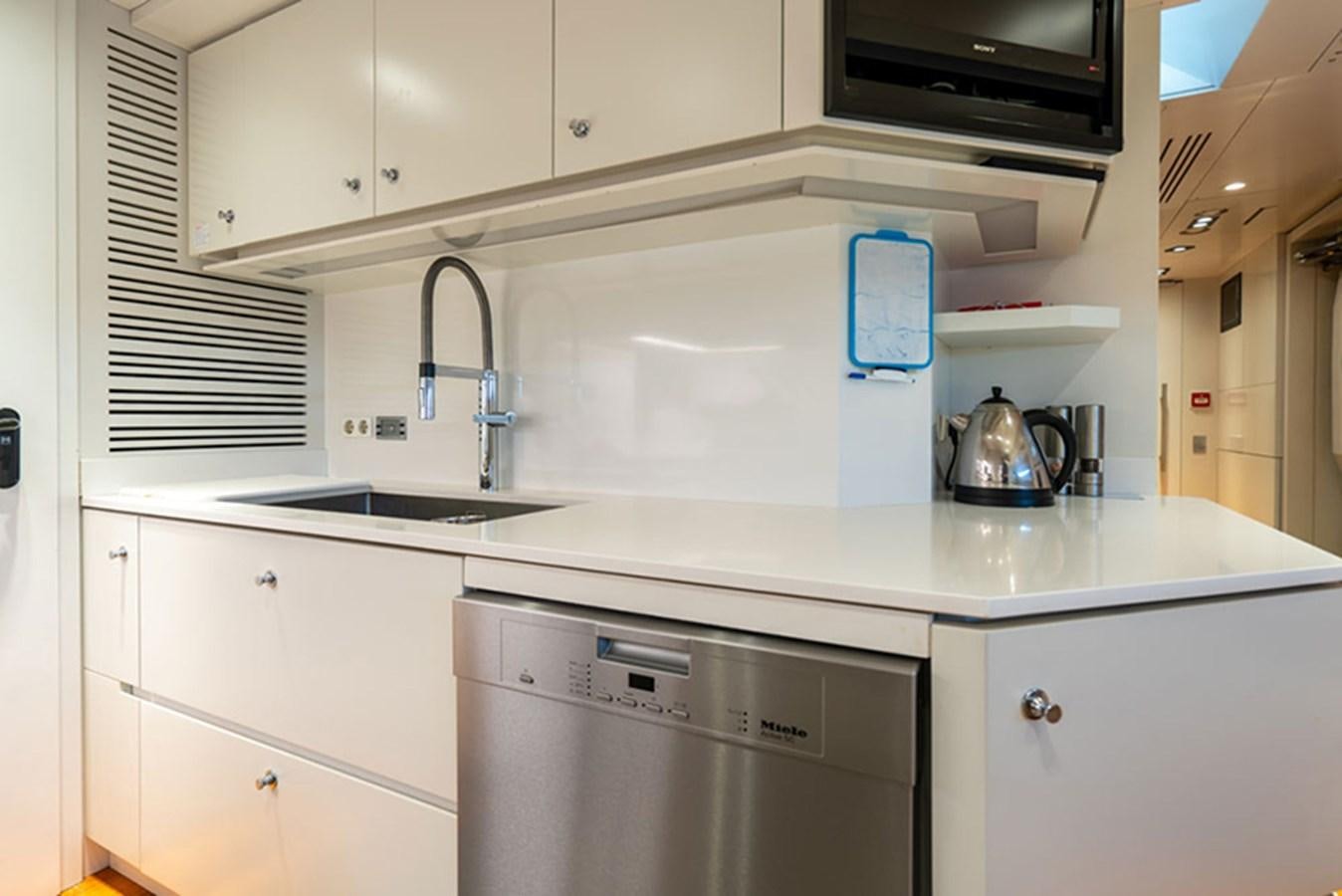a kitchen with white cabinets aboard SAFFURIYA Yacht for Sale