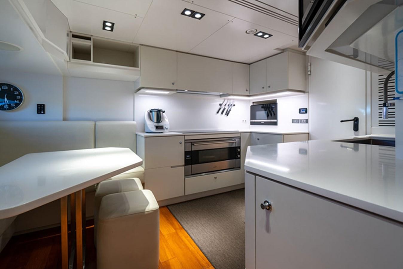 a kitchen with white cabinets aboard SAFFURIYA Yacht for Sale