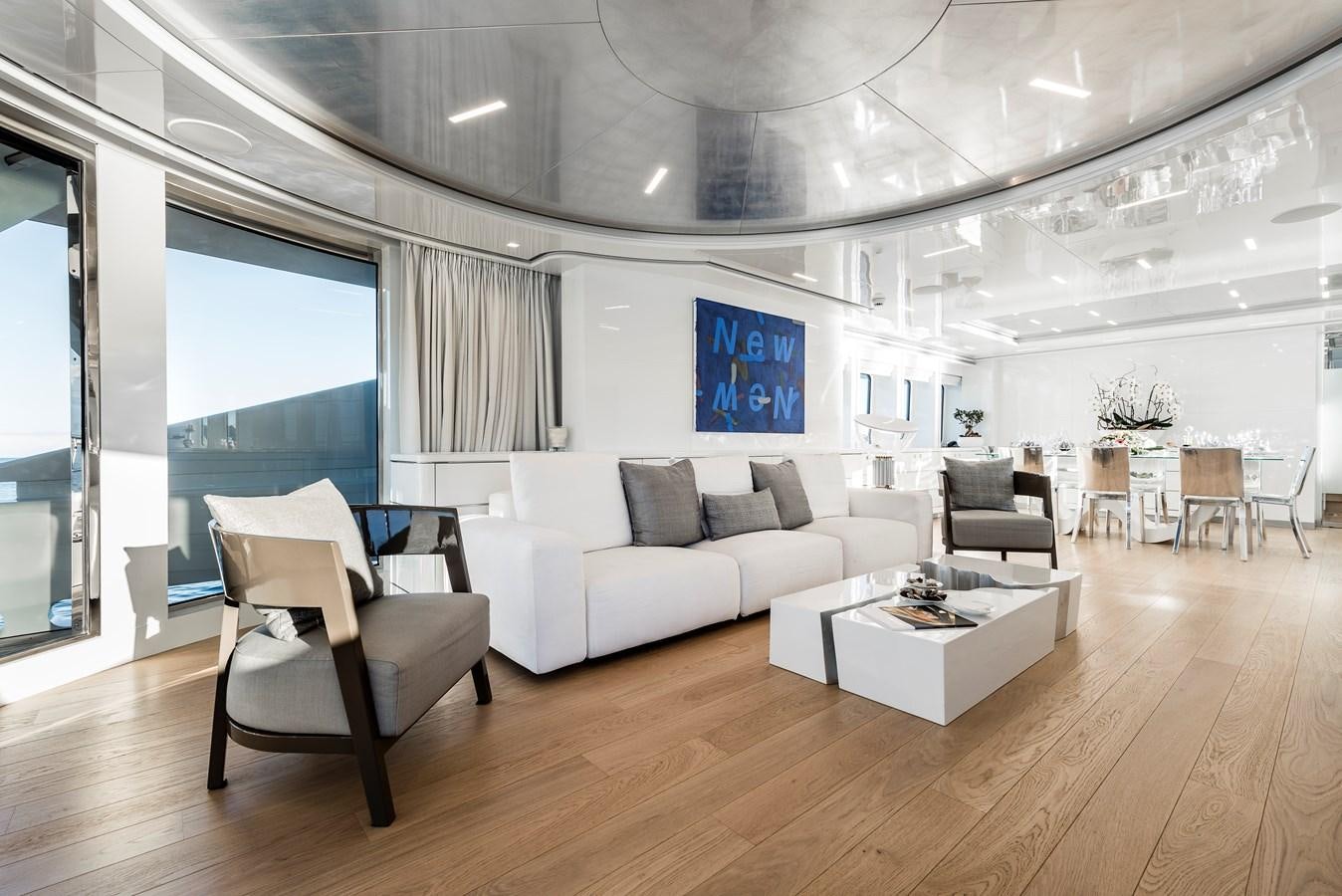 a room with a couch and a table and chairs aboard ANGKALIA Yacht for Sale