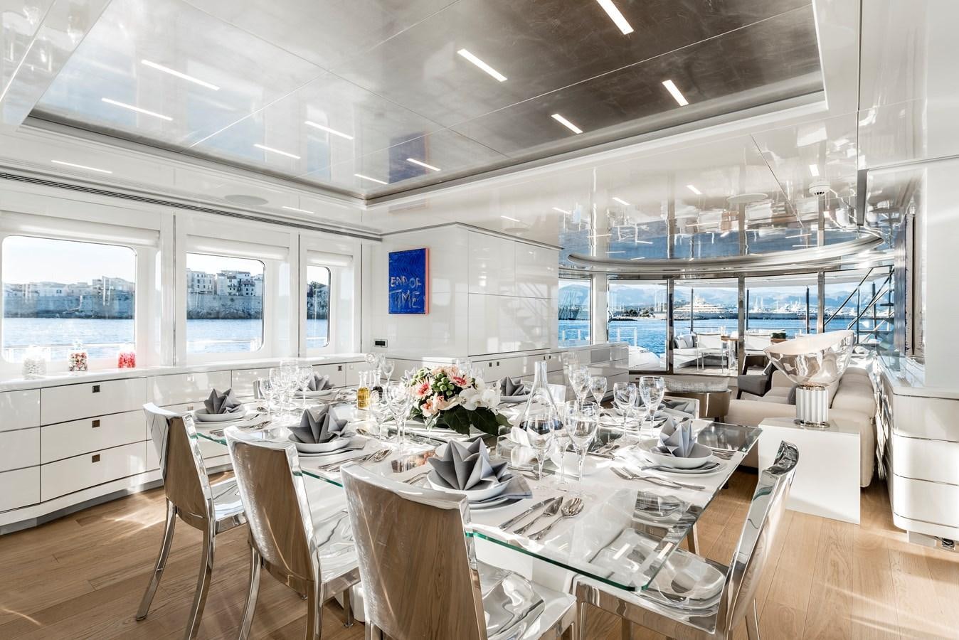 a room with tables and chairs aboard ANGKALIA Yacht for Sale