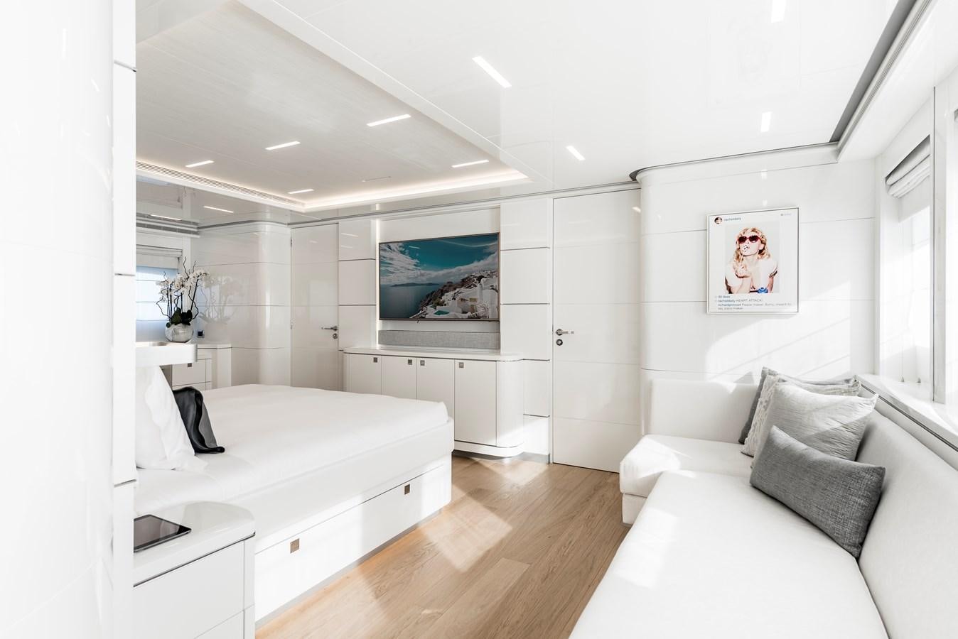 a white bedroom with a wood floor aboard ANGKALIA Yacht for Sale