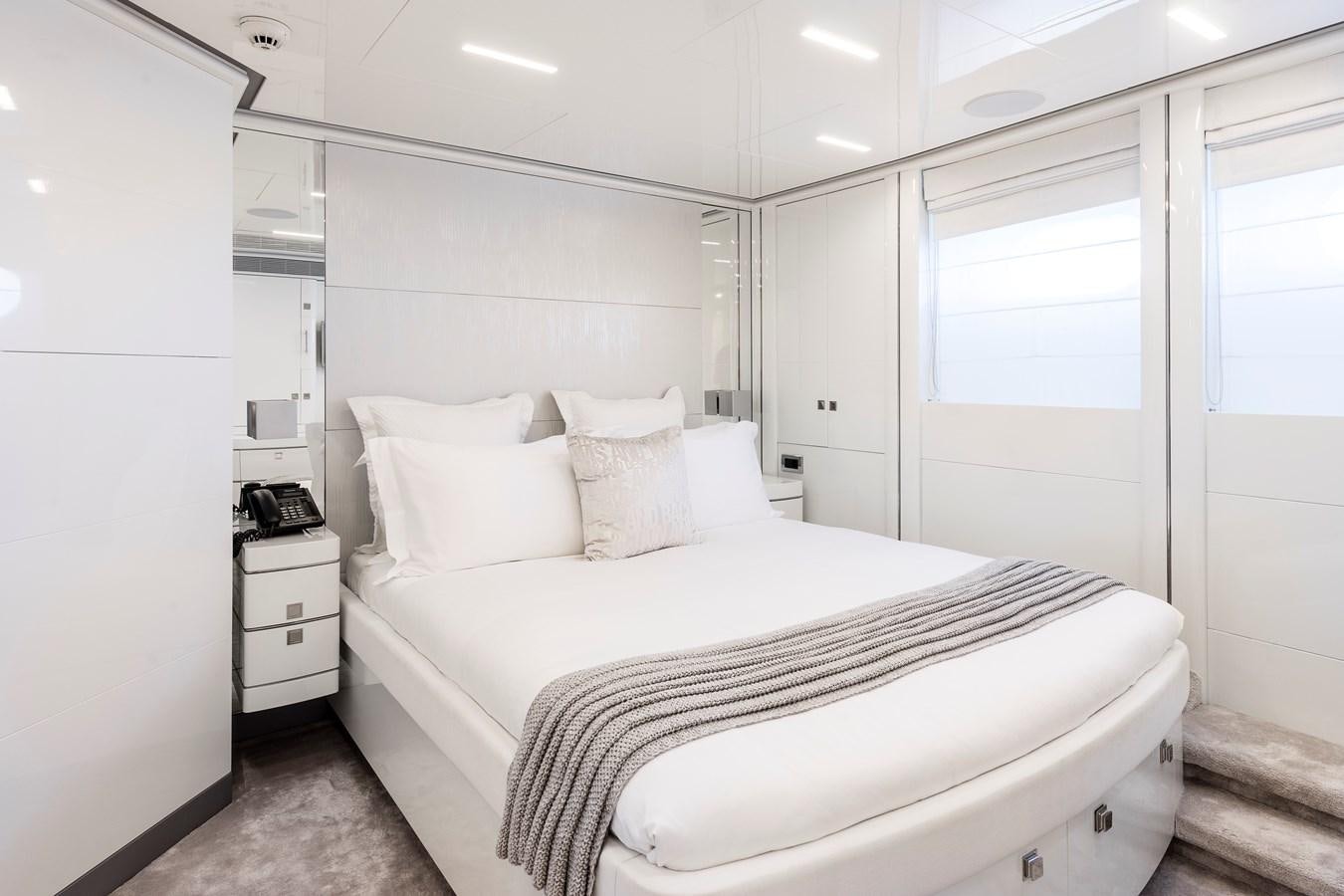 a white bedroom with a bed aboard ANGKALIA Yacht for Sale
