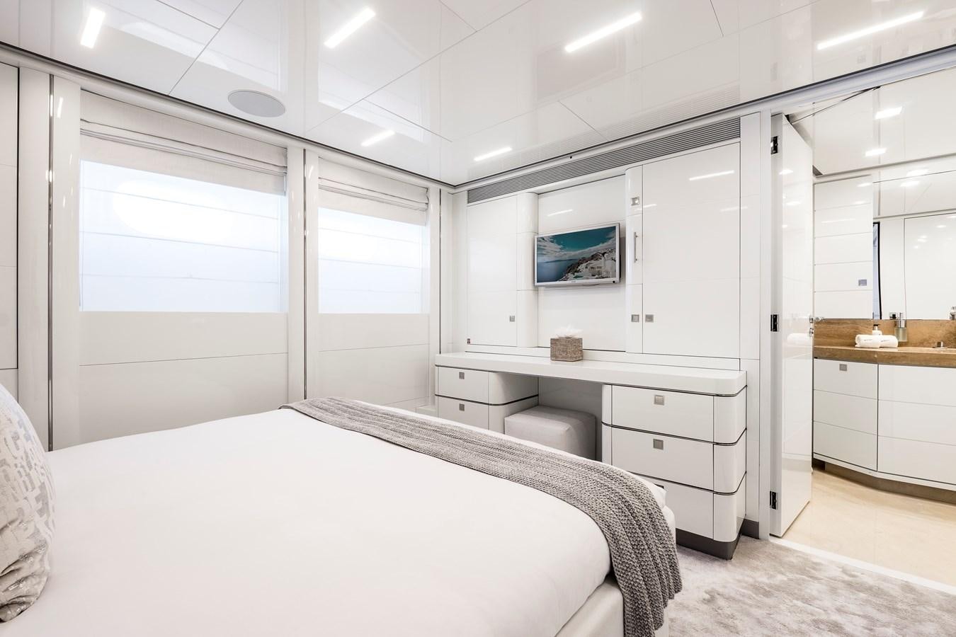 a white bedroom with a bed aboard ANGKALIA Yacht for Sale
