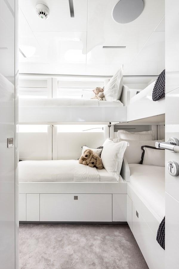 a cat lying on a bed aboard ANGKALIA Yacht for Sale