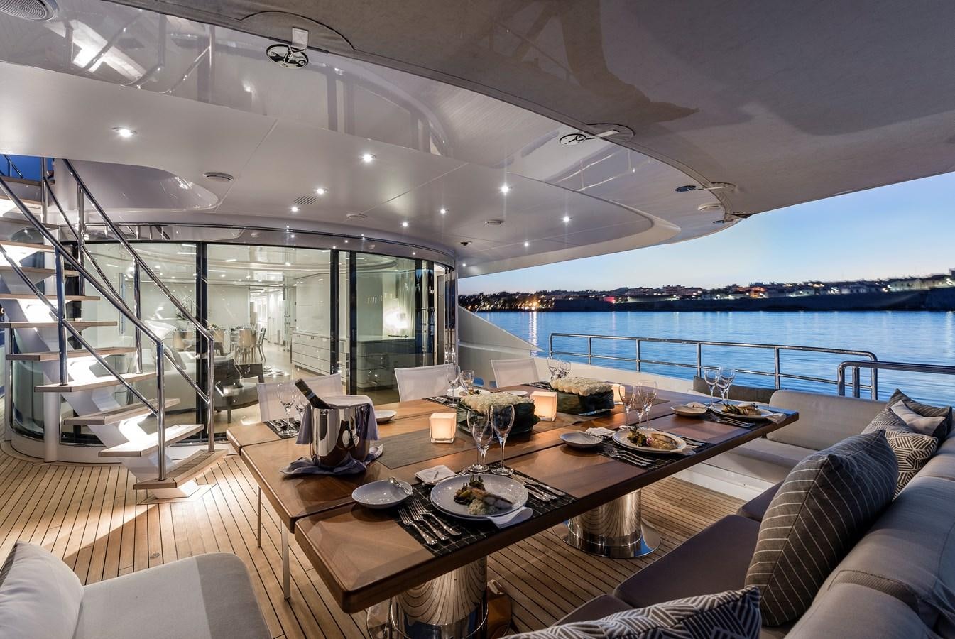 a modern looking living room with a large glass wall aboard ANGKALIA Yacht for Sale