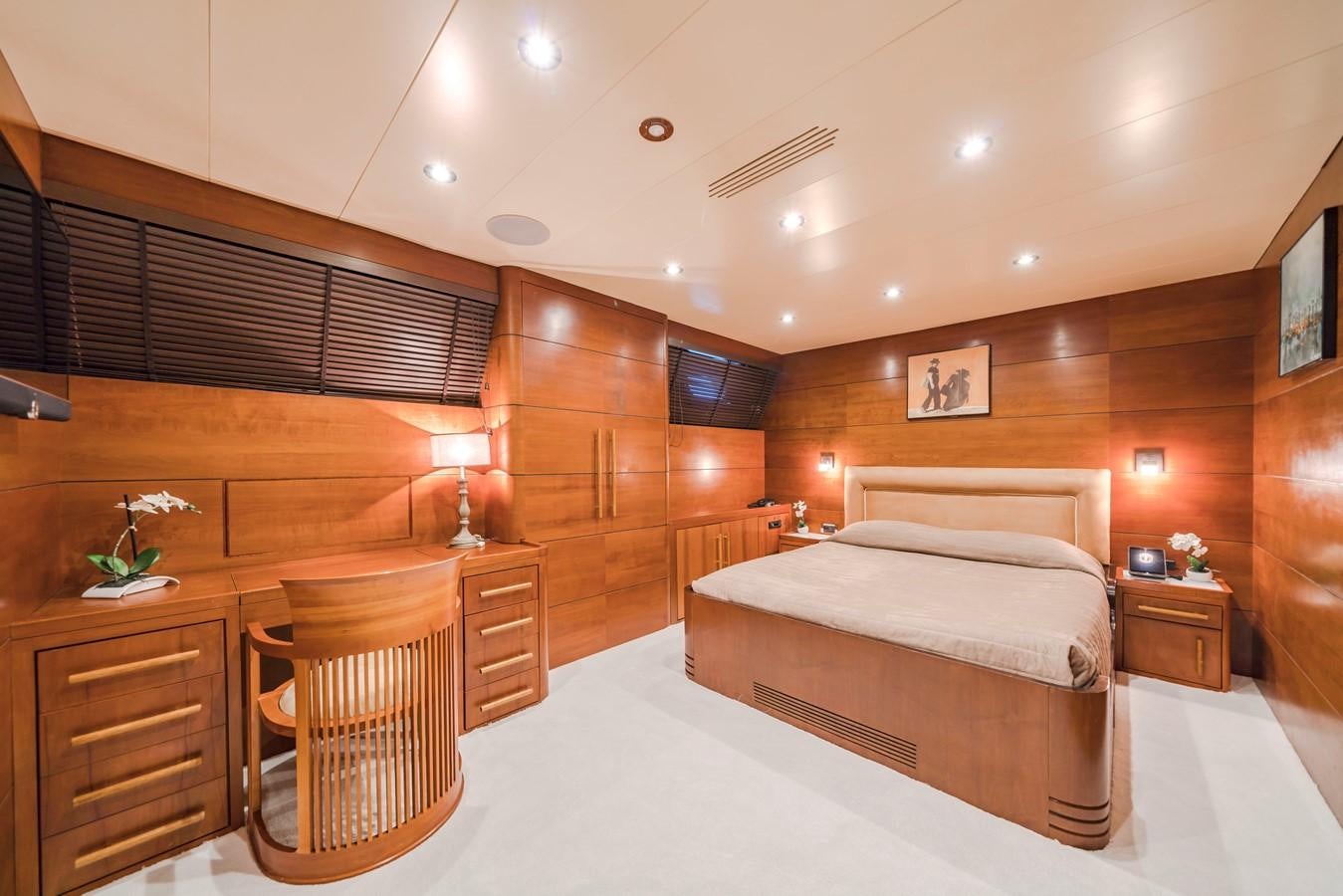 a bedroom with a bed and a chair aboard FIORENTE Yacht for Sale