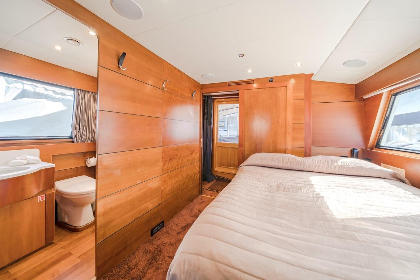 a bedroom with a bed and a mirror aboard FIORENTE Yacht for Sale