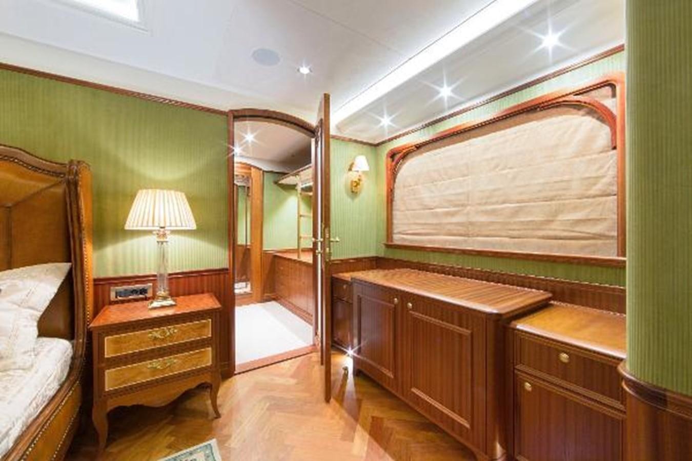 a room with a bed and a mirror aboard 121FT EXPLORER 37 Yacht for Sale