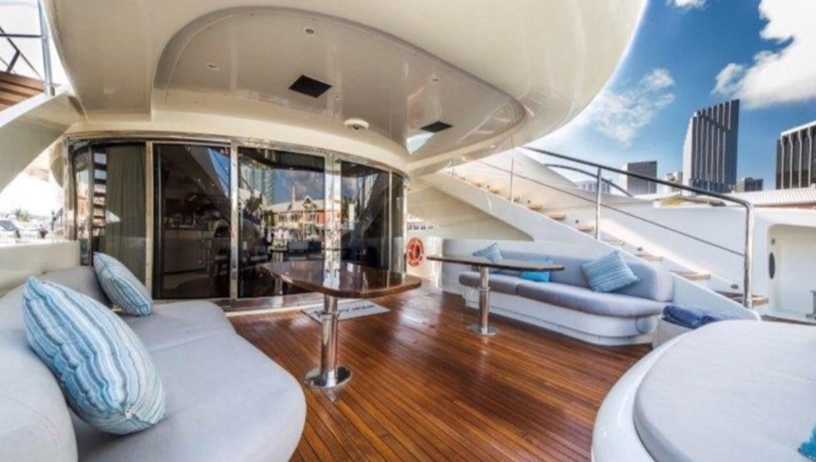 a room with a bed and a table aboard HAPPY HOUR Yacht for Sale