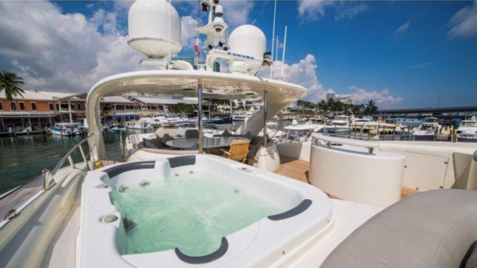 a large white boat on a body of water aboard HAPPY HOUR Yacht for Sale