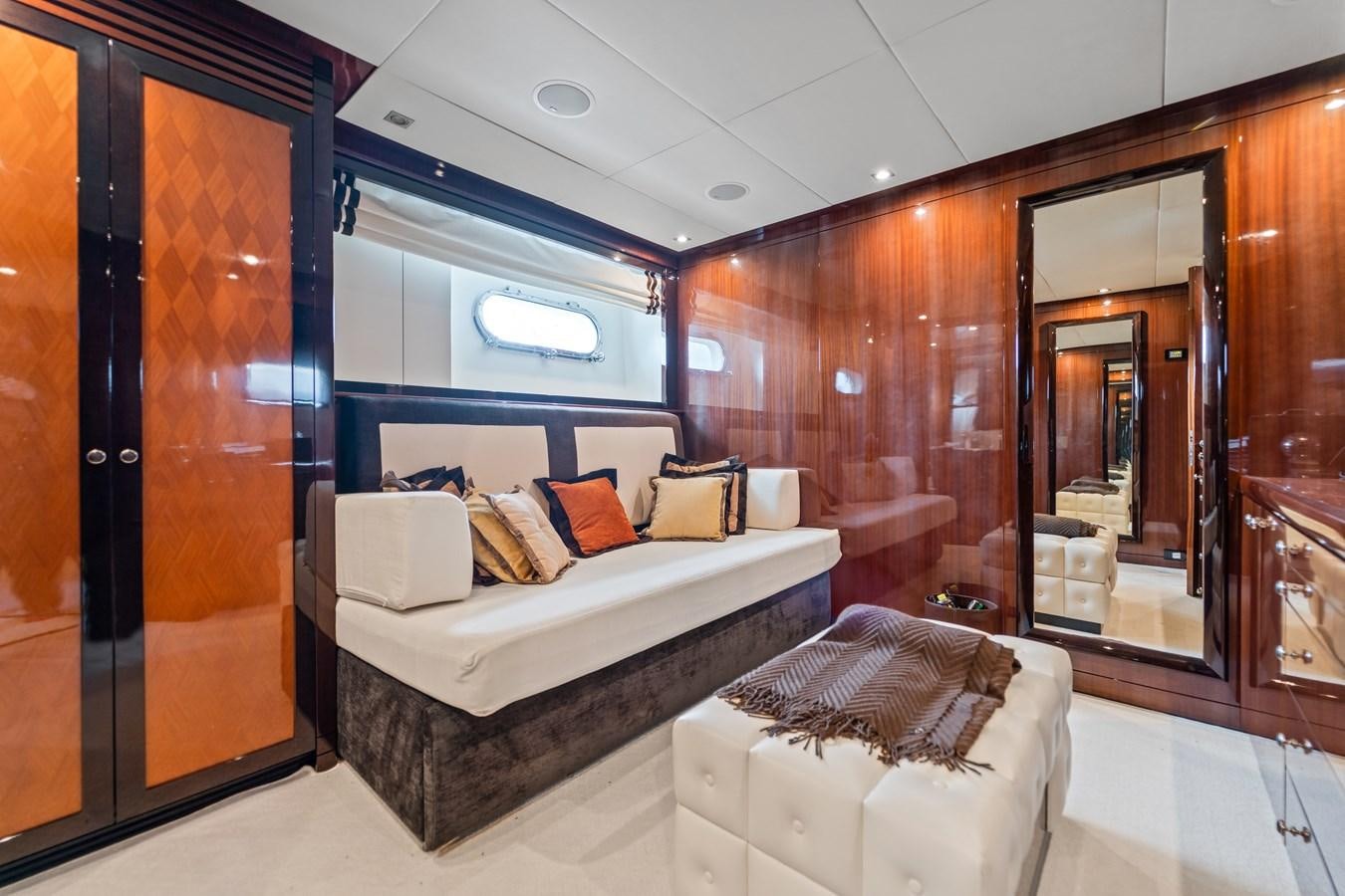 a room with a bed and a chair aboard HAPPY HOUR Yacht for Sale