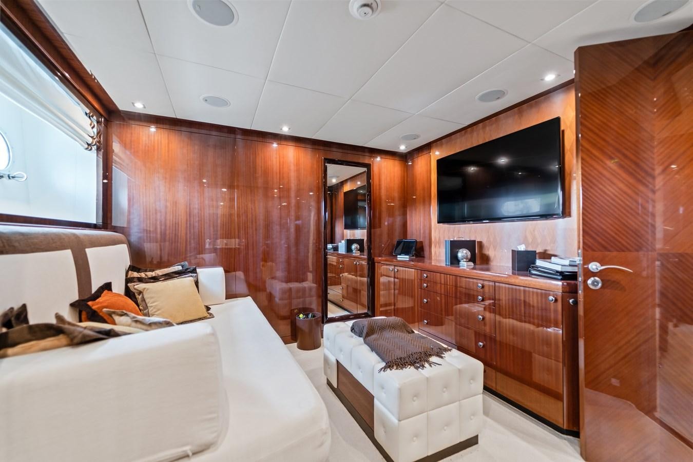 a room with a bed and a wood cabinet aboard HAPPY HOUR Yacht for Sale
