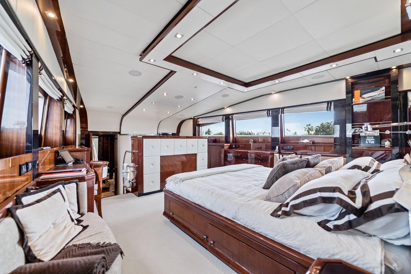 a room with a bed and a large window aboard HAPPY HOUR Yacht for Sale