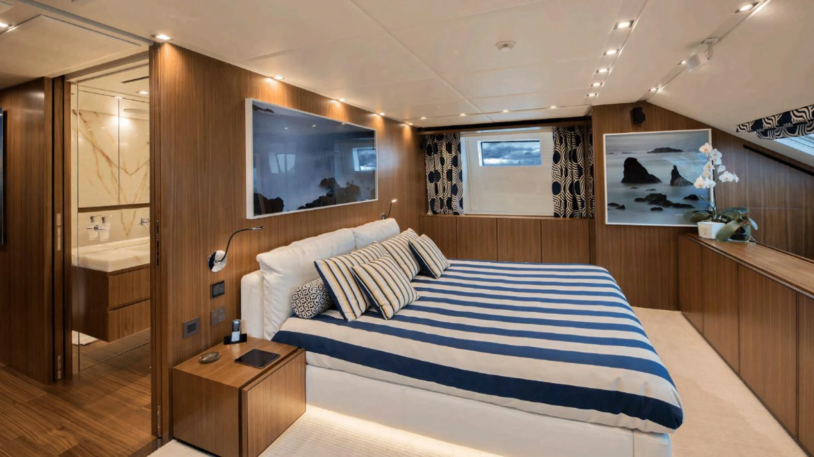 a bedroom with a bed and a television aboard TOUTE SWEET Yacht for Sale