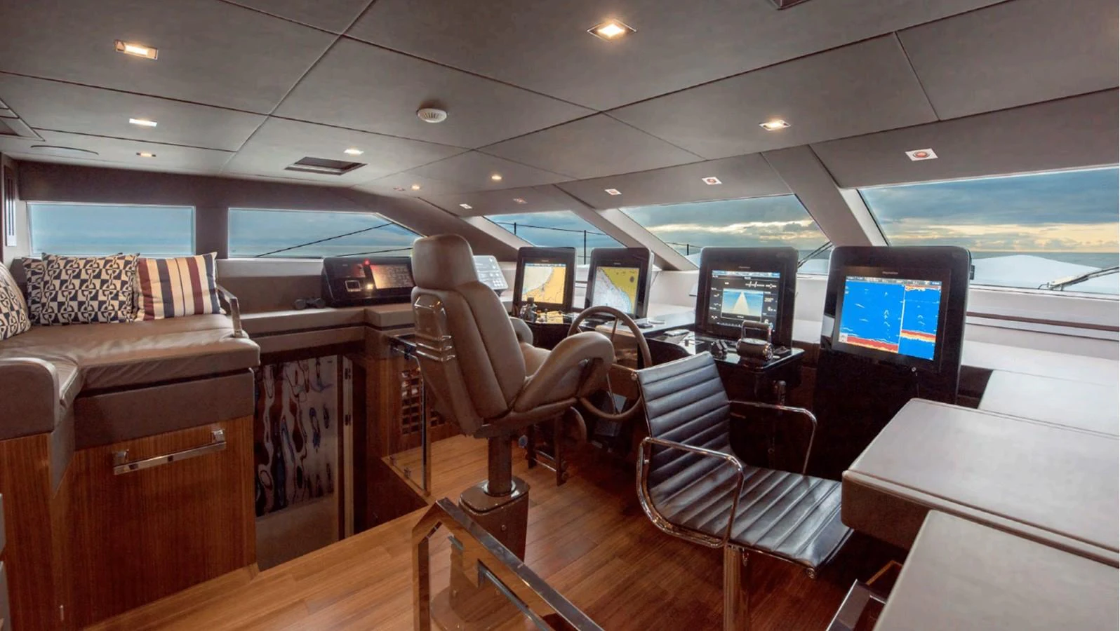 a room with a couch and a tv on the wall aboard TOUTE SWEET Yacht for Sale