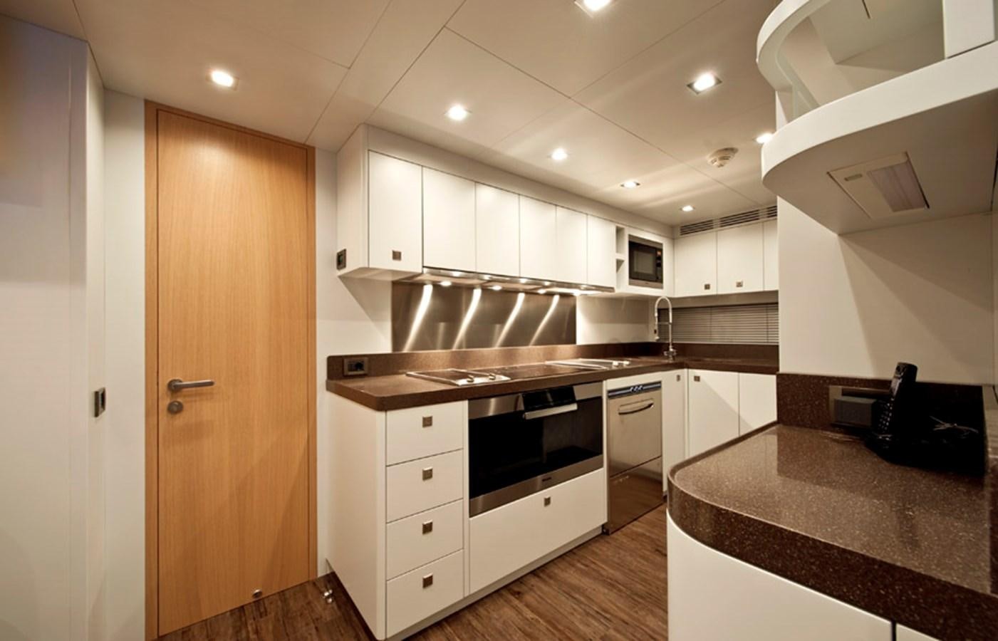 a kitchen with white cabinets aboard MUSA Yacht for Sale