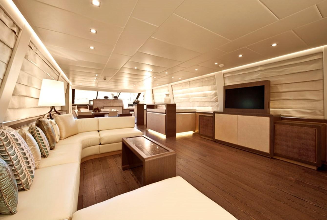 a living room with a large television aboard MUSA Yacht for Sale