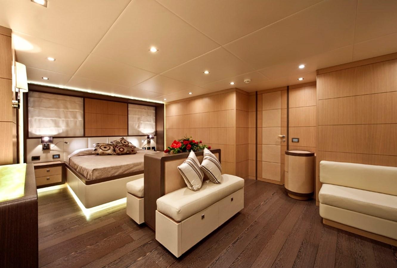 a room with a bed and a couch aboard MUSA Yacht for Sale