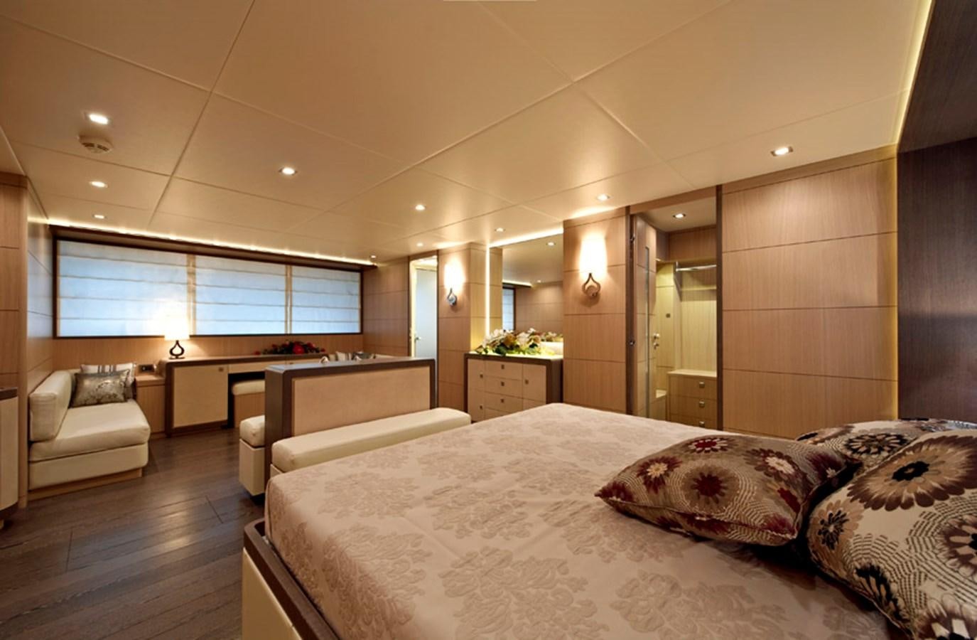 a room with a bed and a table aboard MUSA Yacht for Sale