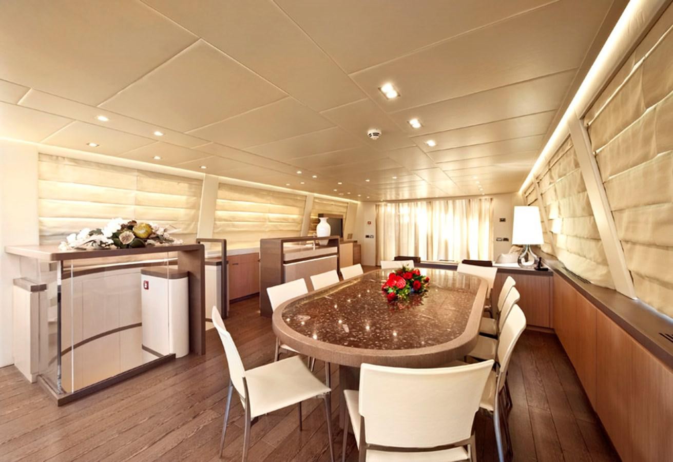 a large kitchen with a table and chairs aboard MUSA Yacht for Sale