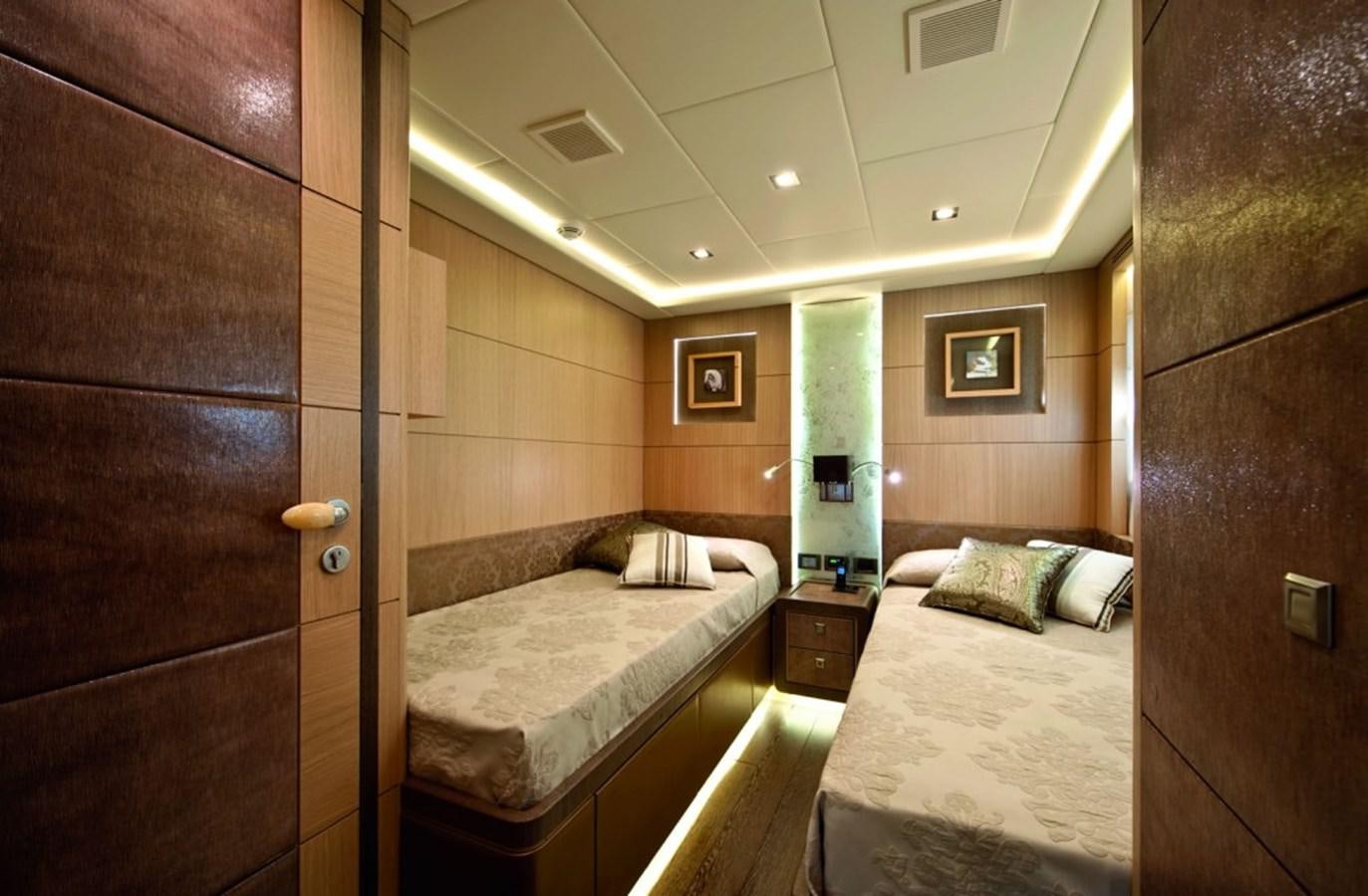 a bedroom with a bed and a door aboard MUSA Yacht for Sale