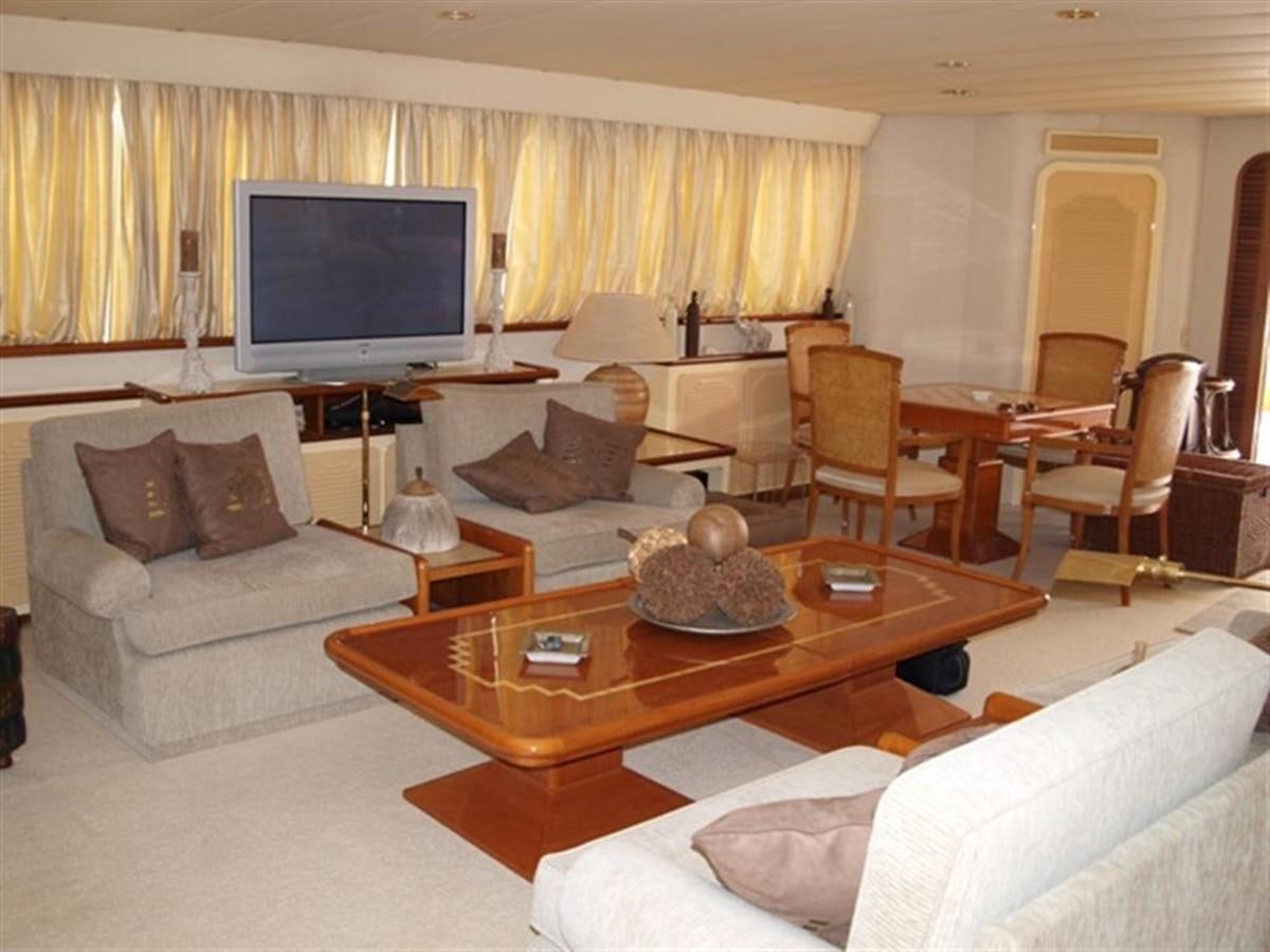 a living room with a tv and couches aboard PARADIS Yacht for Sale