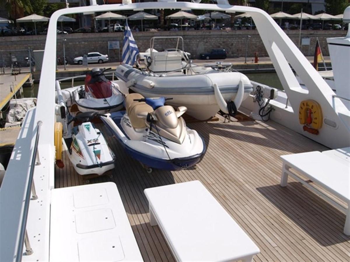 a small white boat on a dock aboard PARADIS Yacht for Sale