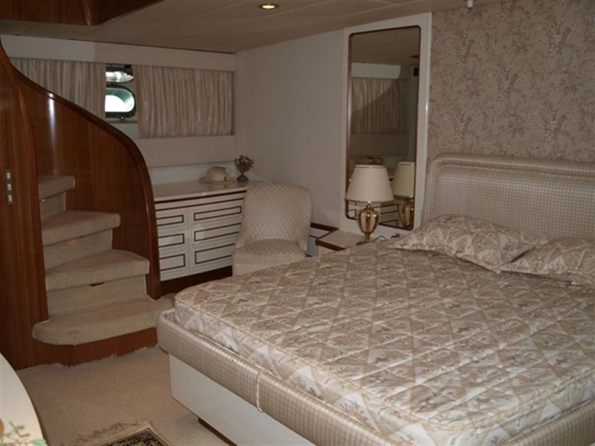 a bedroom with a bed and a staircase aboard PARADIS Yacht for Sale