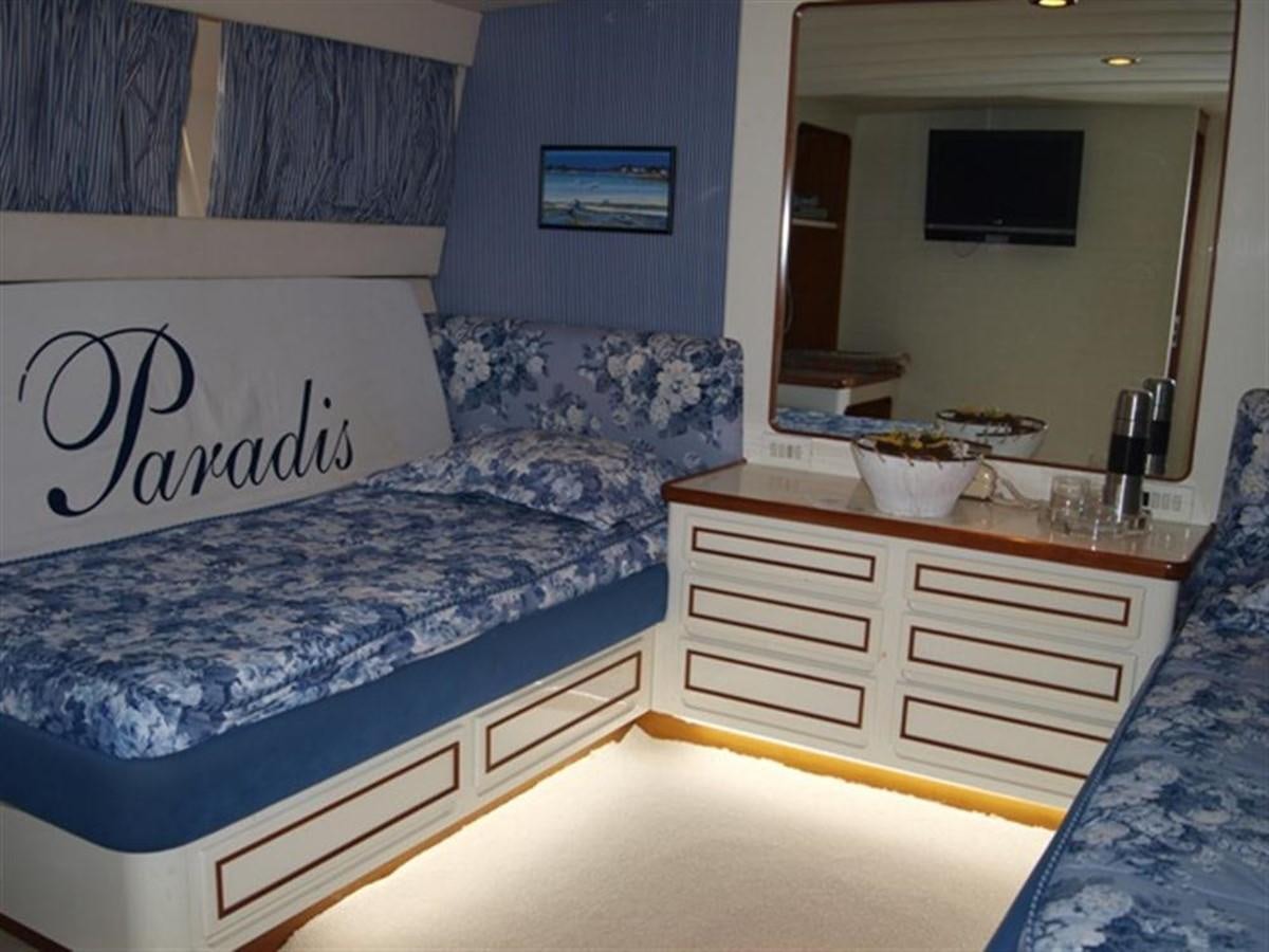 a room with a bed and a desk aboard PARADIS Yacht for Sale