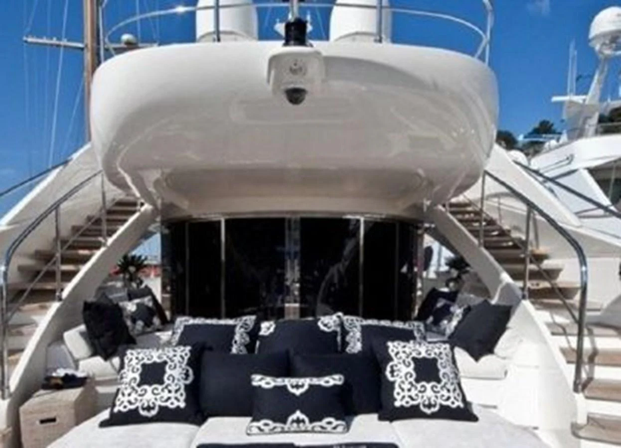a group of people sitting on a chair in front of a large space ship aboard ISA 120 Yacht for Sale