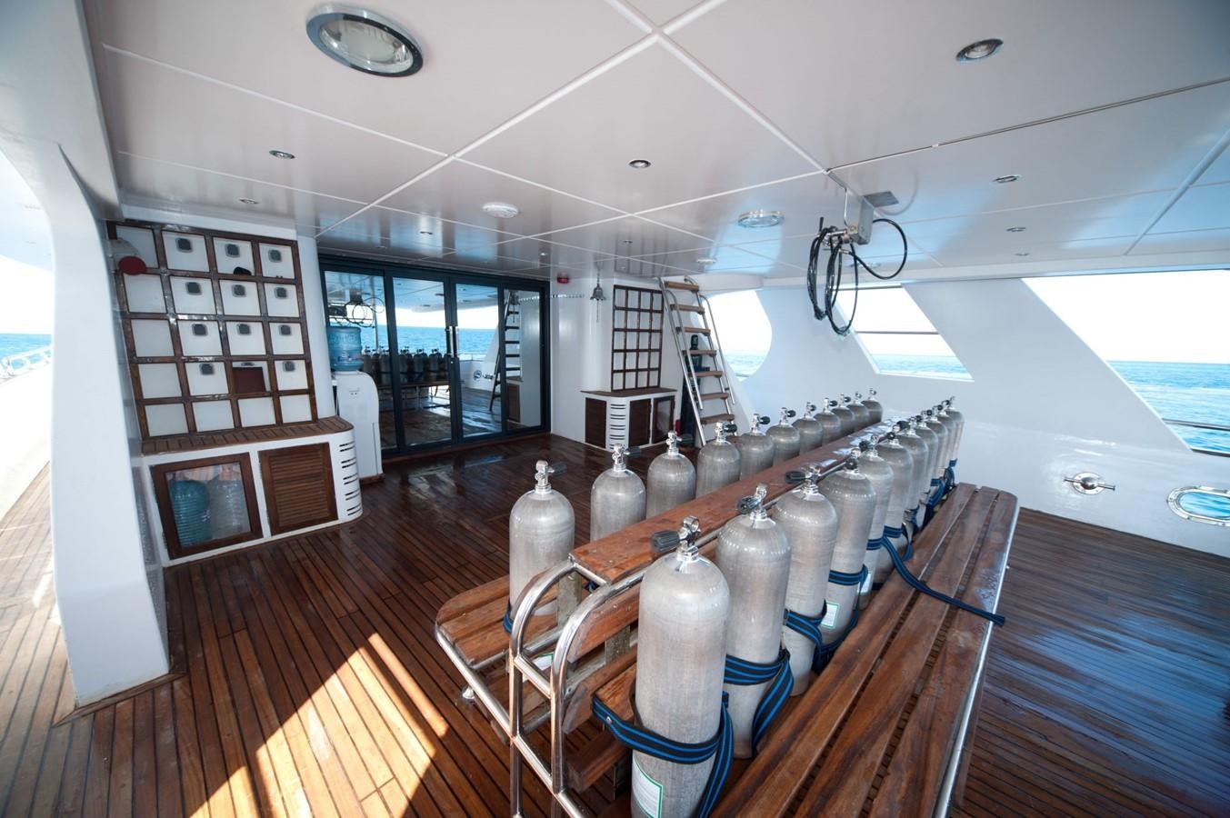 a room with many bottles on shelves aboard BETELGUESER Yacht for Sale
