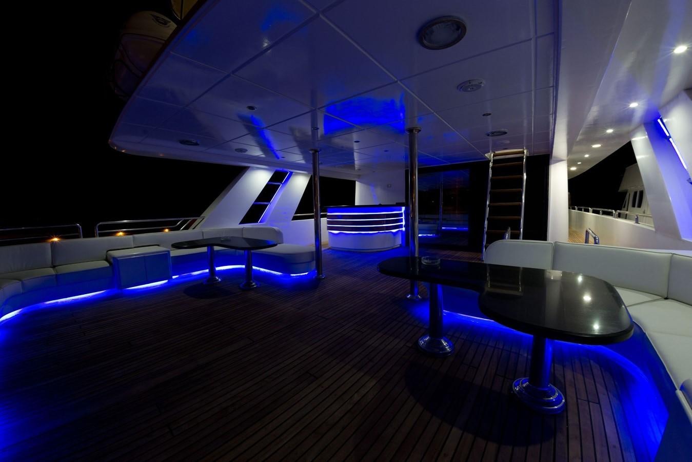 a room with tables and chairs aboard BETELGUESER Yacht for Sale