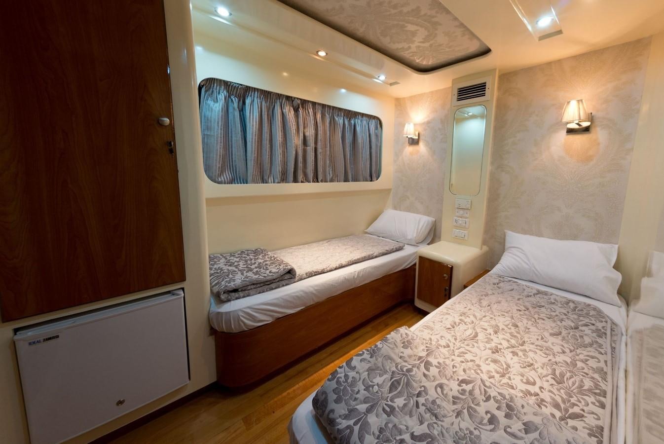 a room with two beds aboard BETELGUESER Yacht for Sale