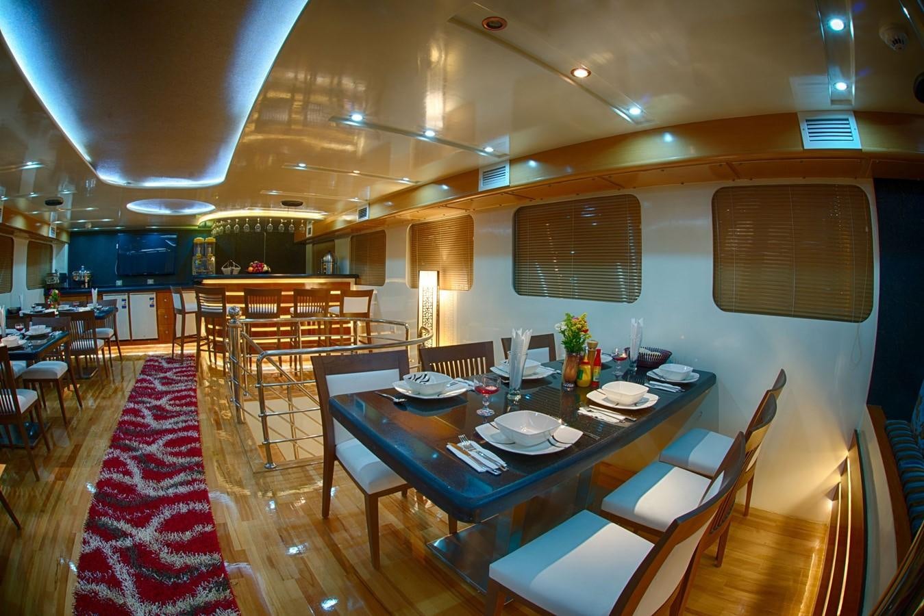 a restaurant with tables and chairs aboard BETELGUESER Yacht for Sale