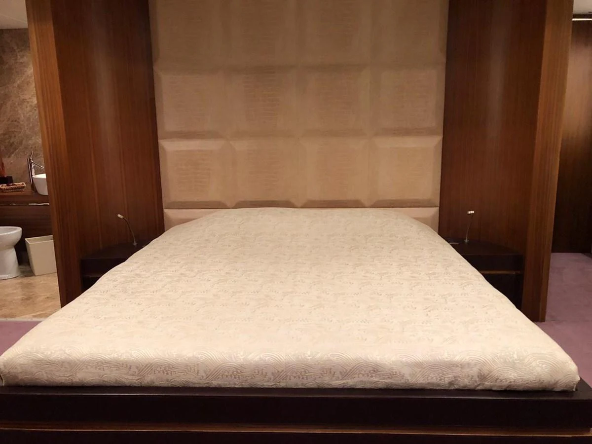 a bed with a white sheet aboard GINEVRA Yacht for Charter