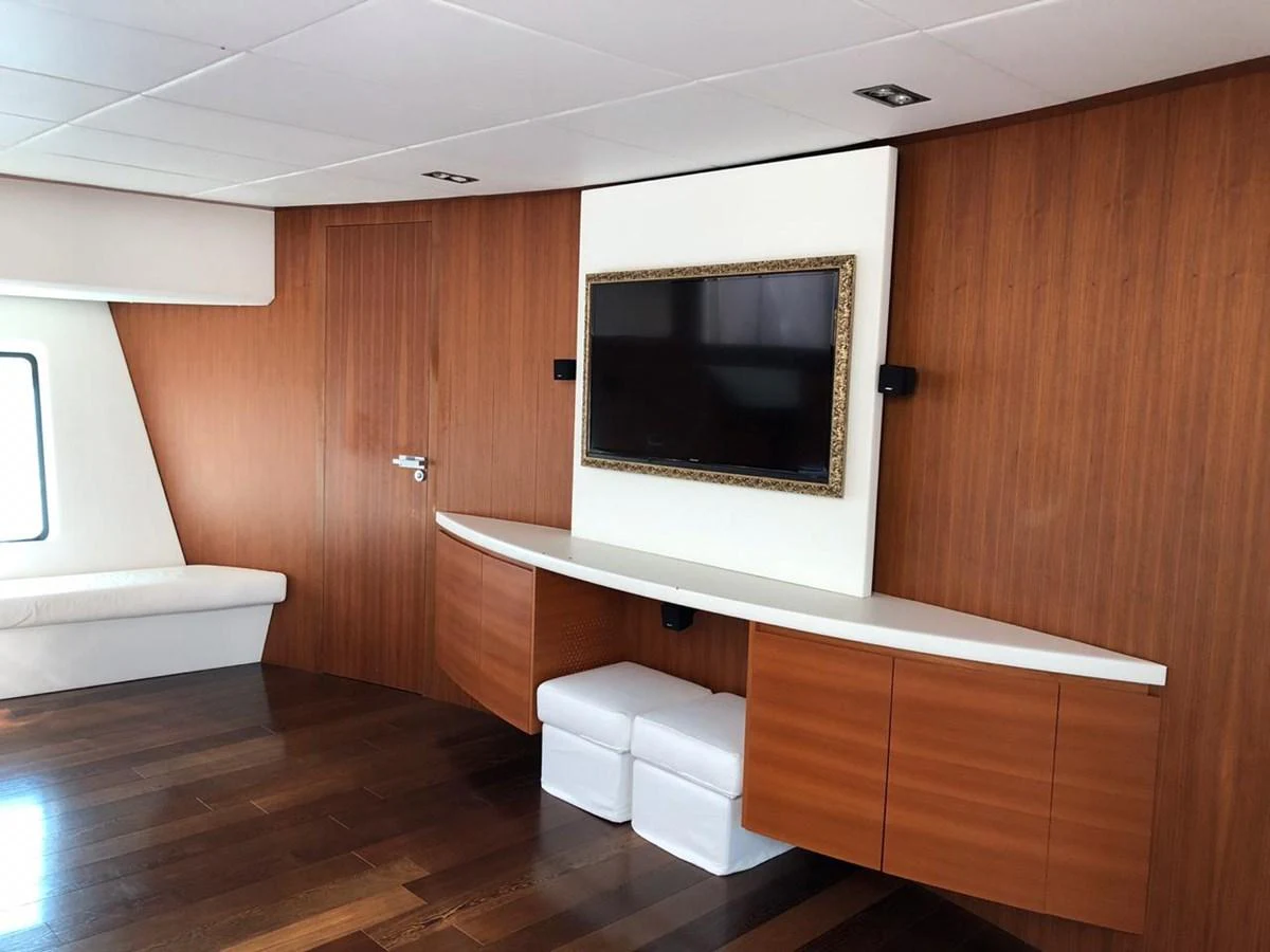 a room with a wood wall and a television on the wall aboard GINEVRA Yacht for Charter